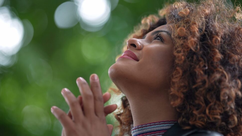 curly hair woman looking above