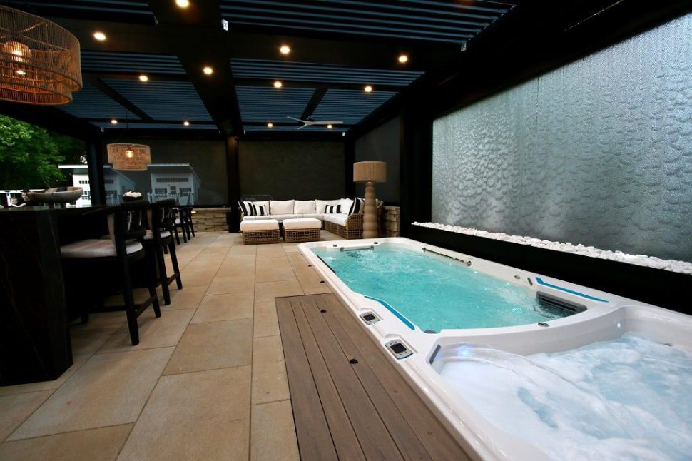A modern pergola providing shade over a luxurious hot tub area