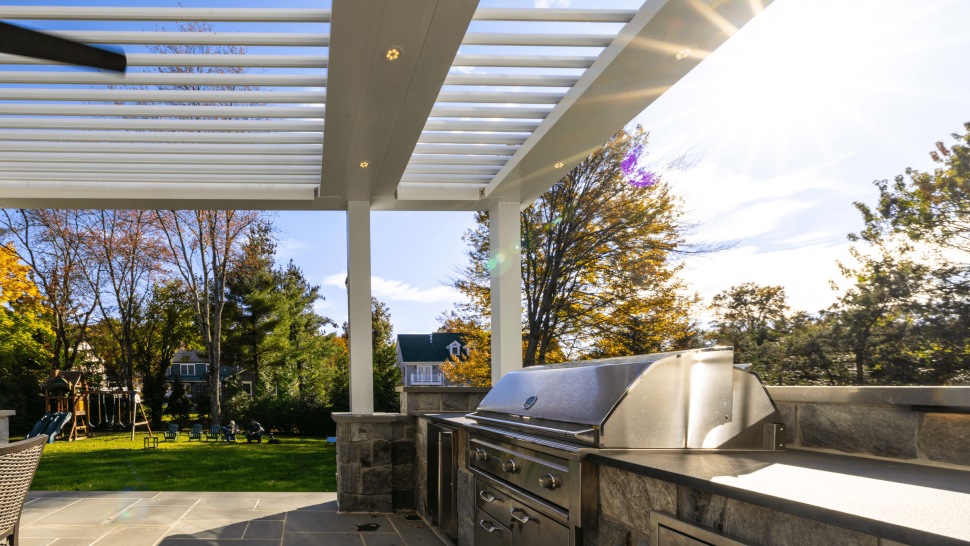 white outdoor Pergola with customized outdoor kitchen