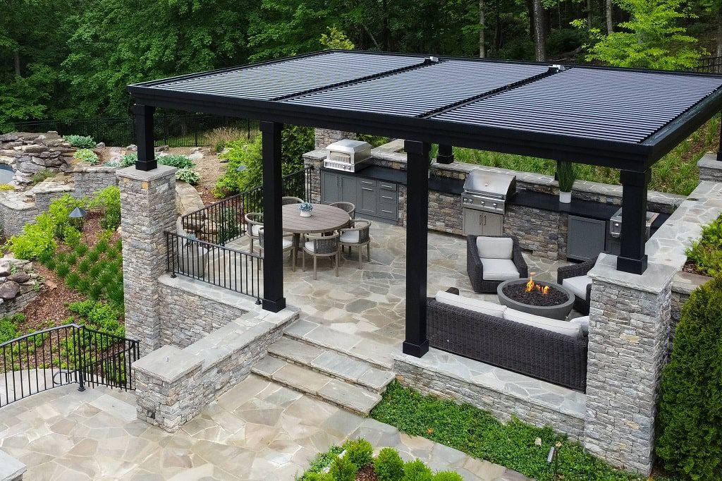 Pergola X by StruXure creates shade and shelter over a stunning  outdoor kitchen.