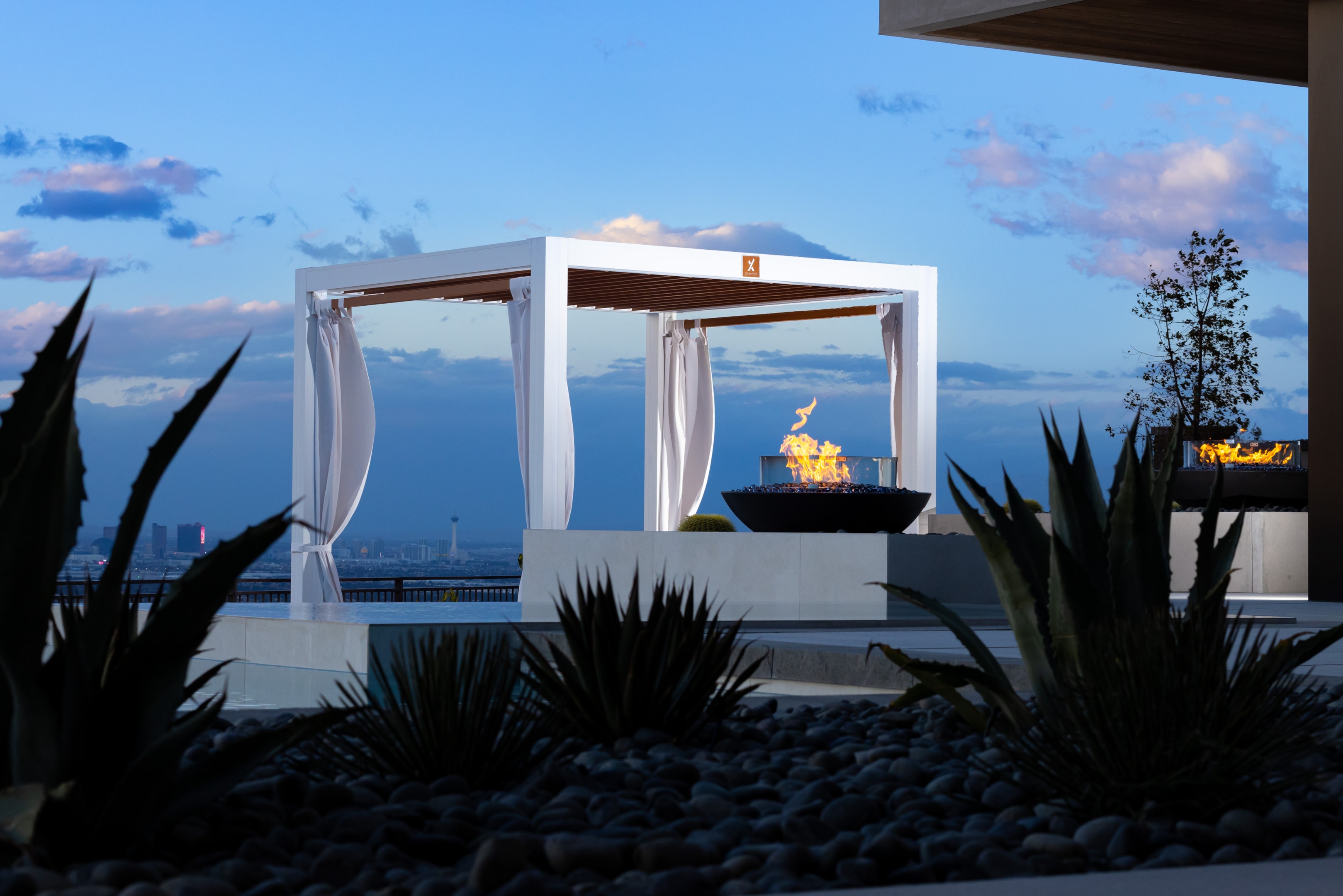 An elegant Cabana X in an outdoor pool and seating area.