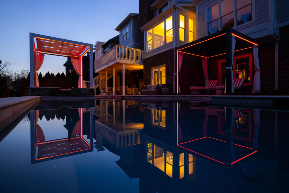 Backyard patio area at sunset near a pool