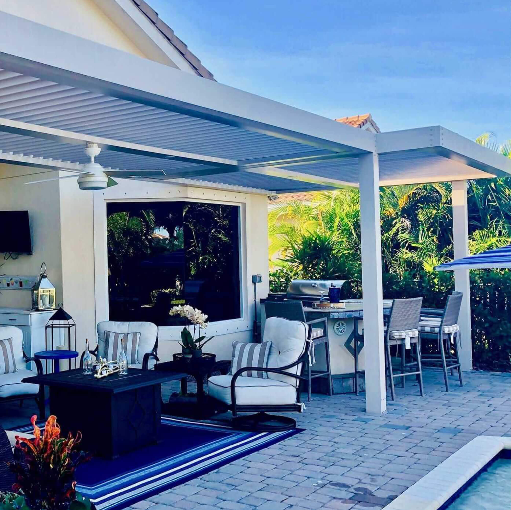 mid side view outdoor extension Pergola with kitchen appliances tables and chair