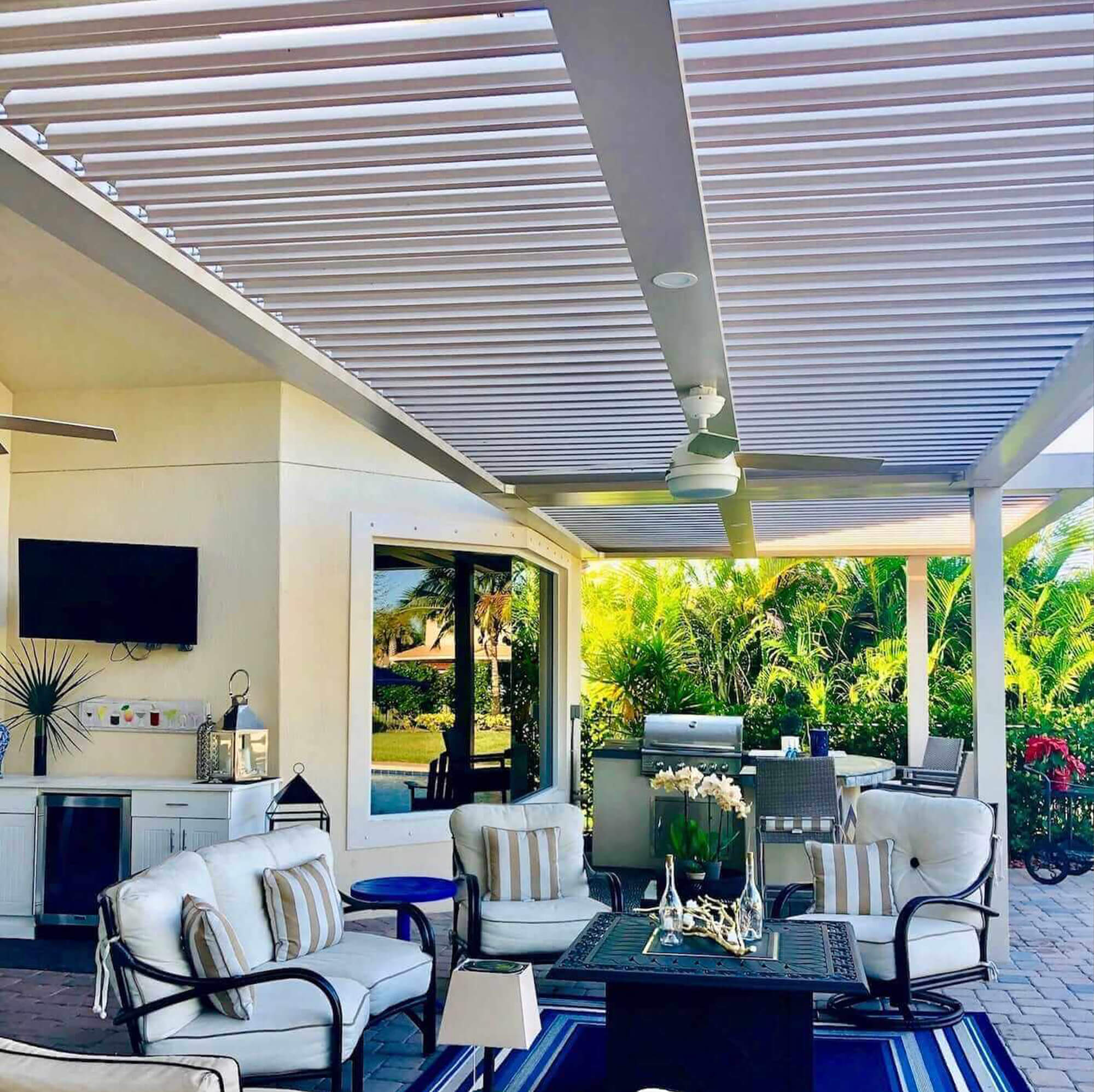inside view outdoor extension Pergola with kitchen appliances tables and chair