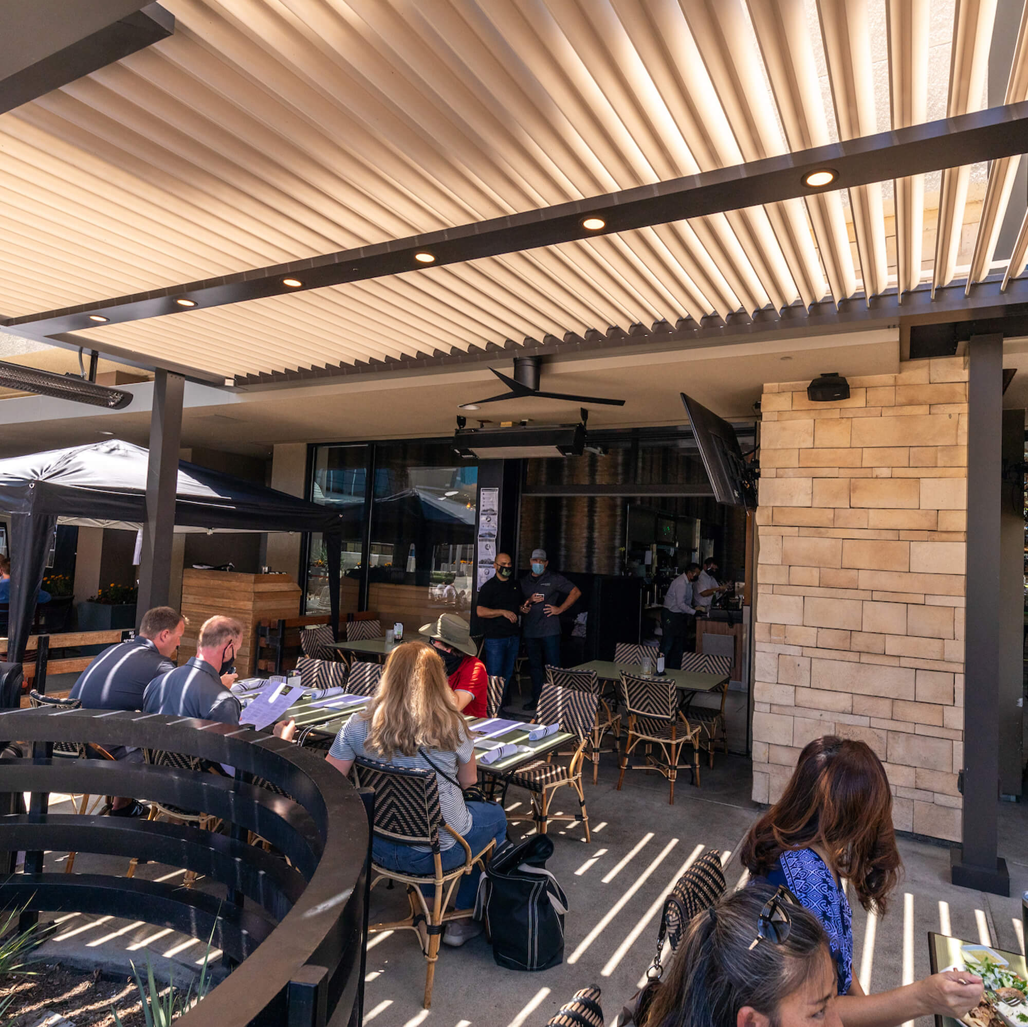 outdoor extension restaurant with customers checking the menu
