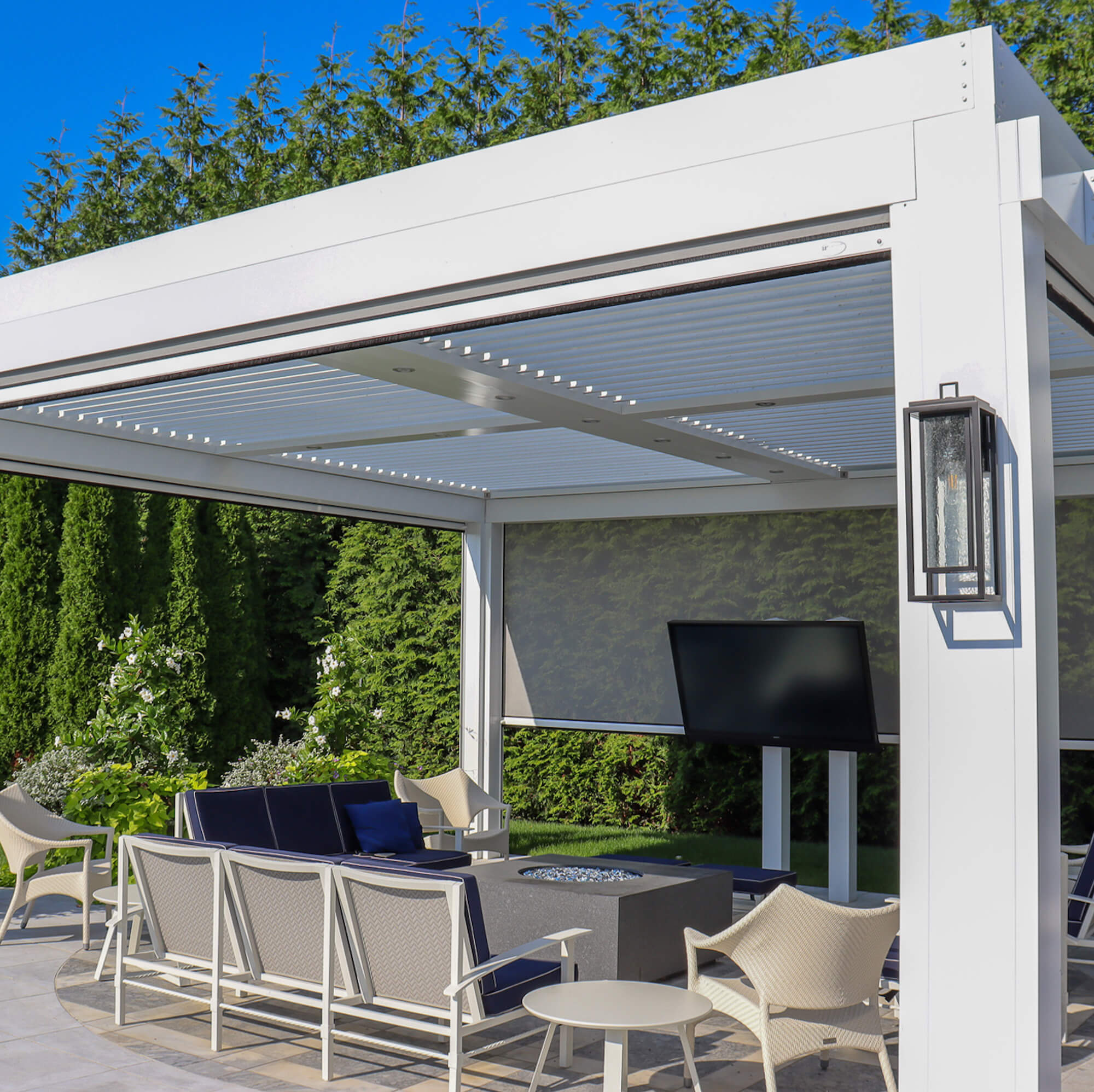 white outdoor canopy design with blue pillow and hanging lights