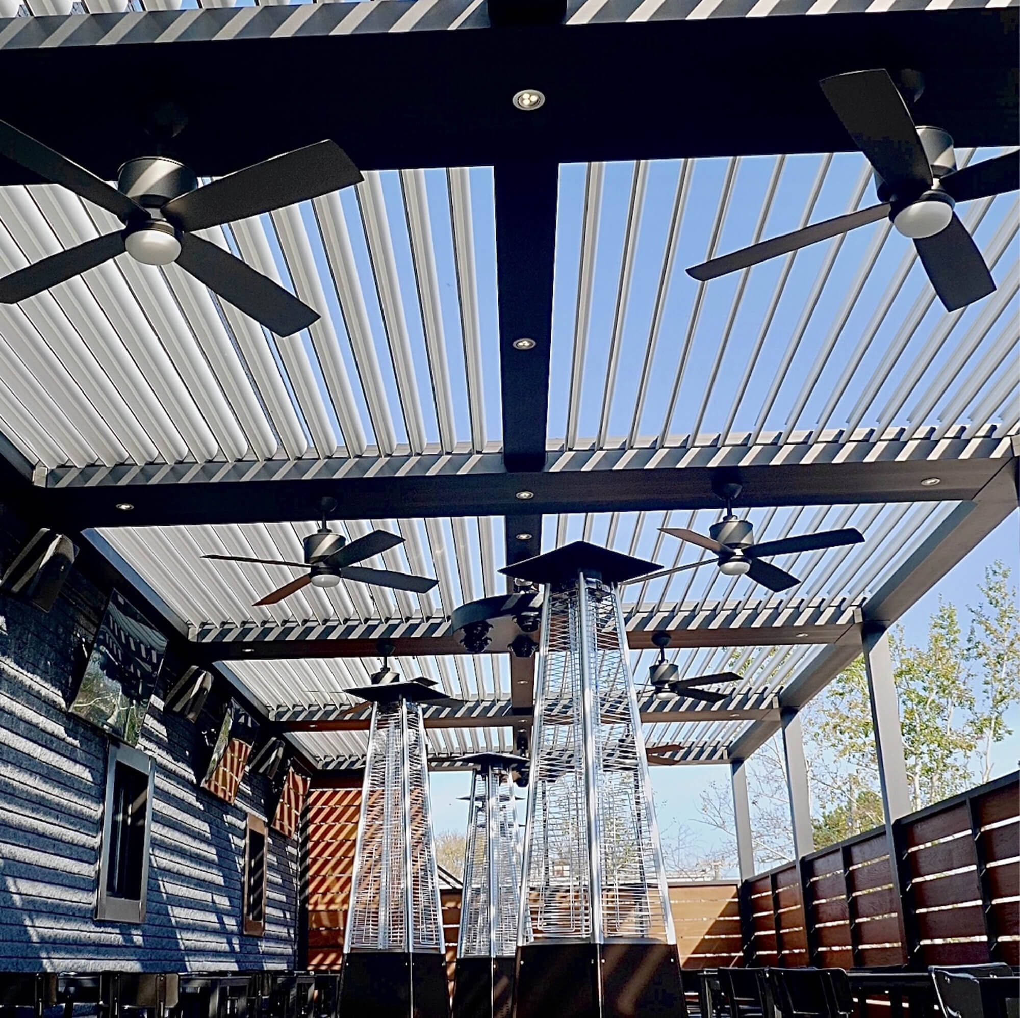 upper view of black outdoor Pergola with lights and fan