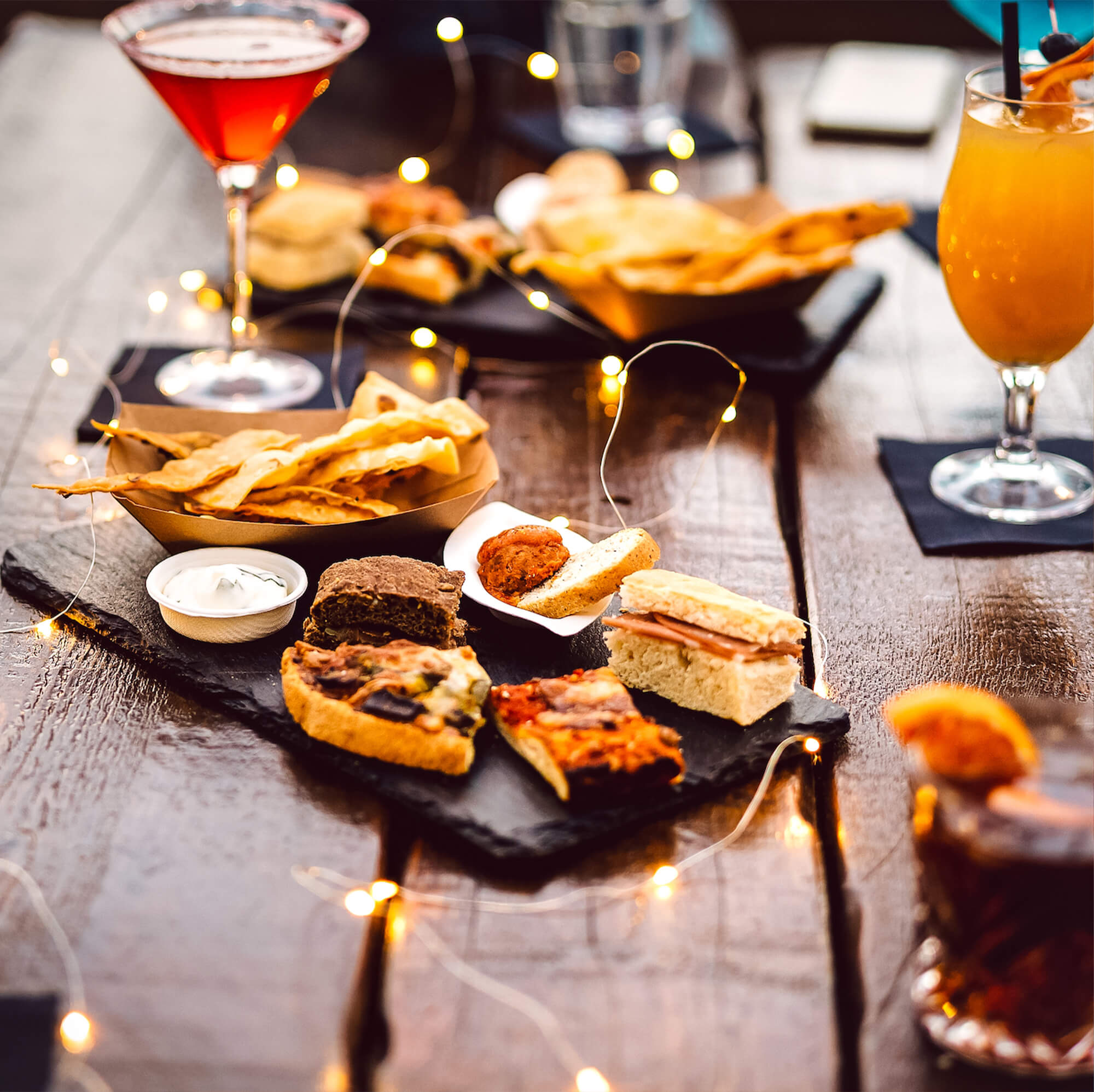 cocktail drinks with finger food on the table
