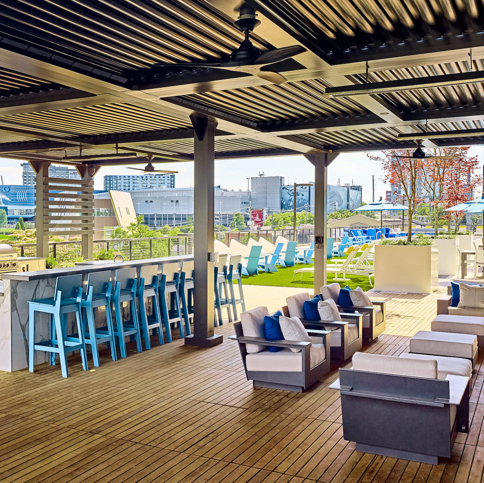 outdoor canopy view facing outside with blue chairs and white brown sofa