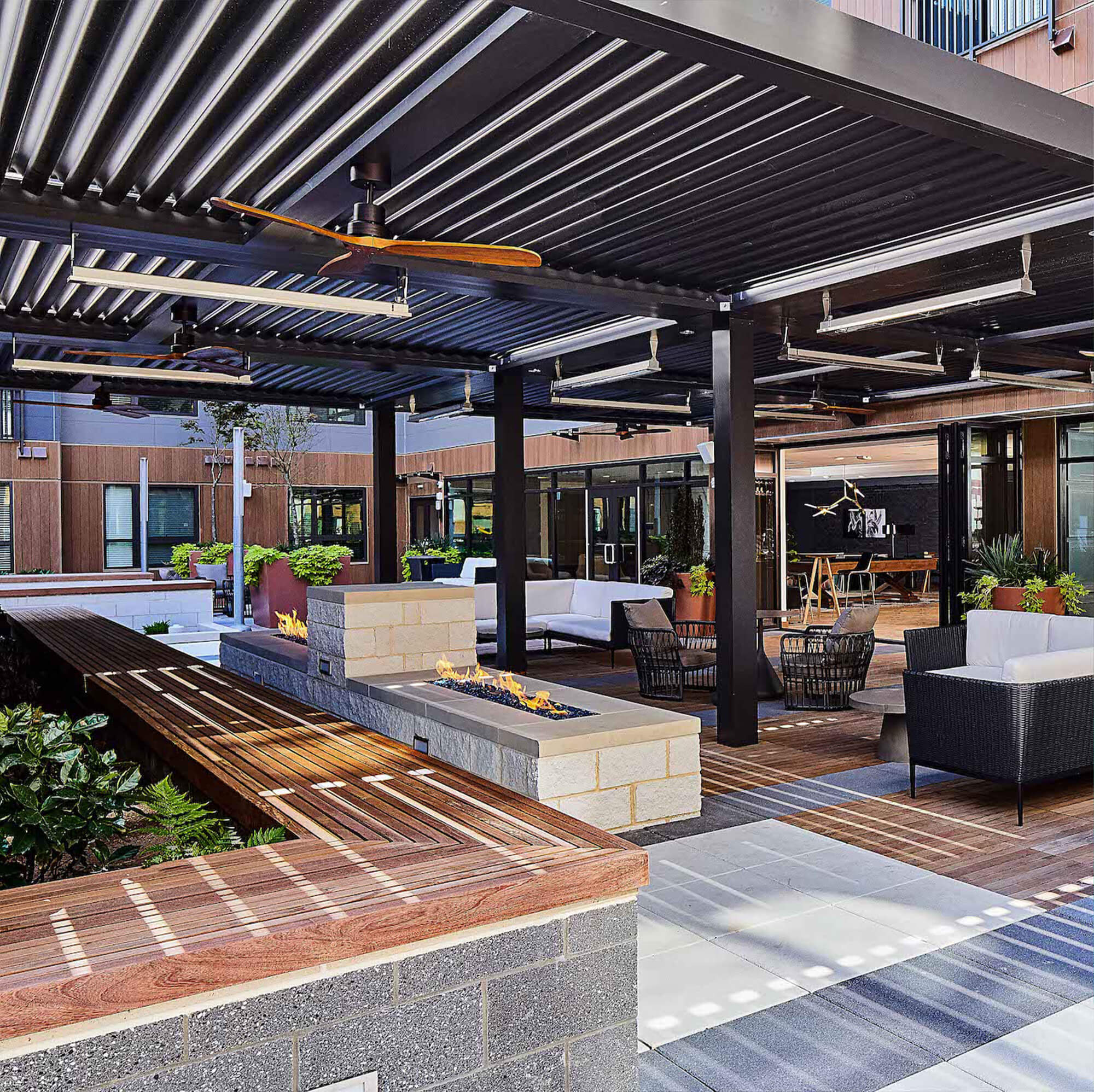 brown metal canopy with fire place and chairs and tables