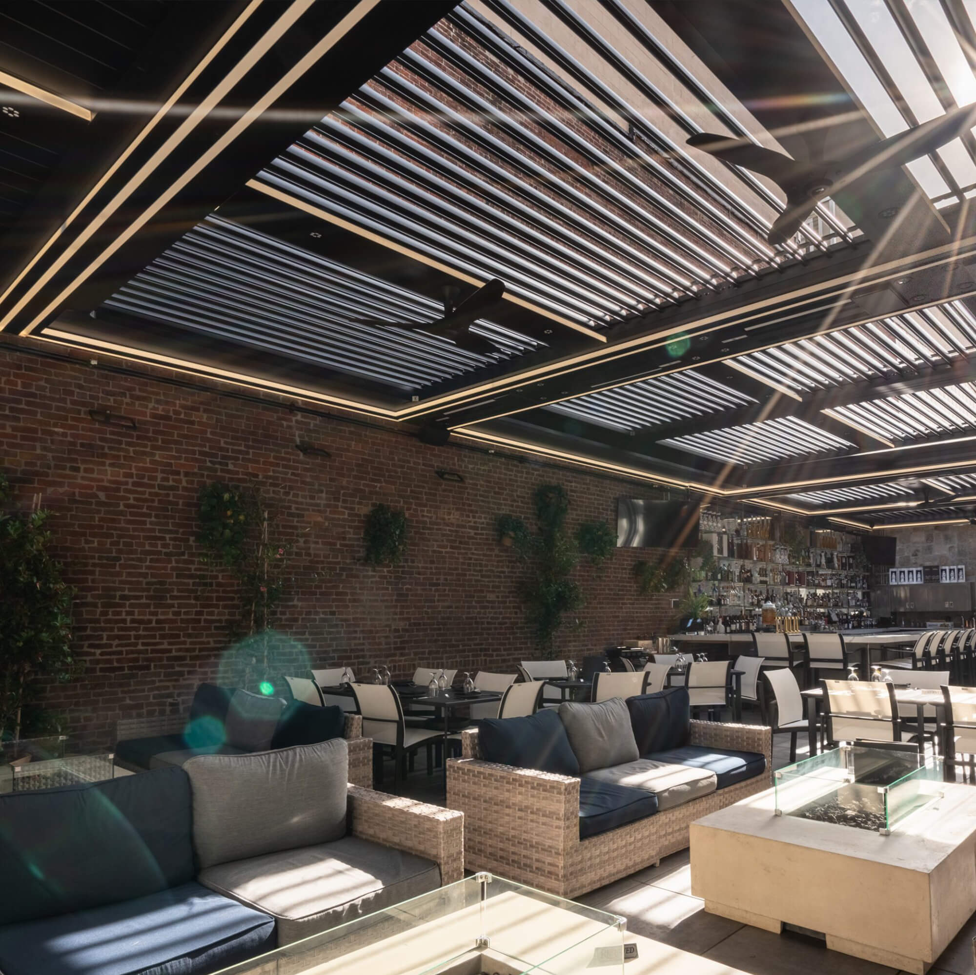 Outdoor bar area with brick walls.