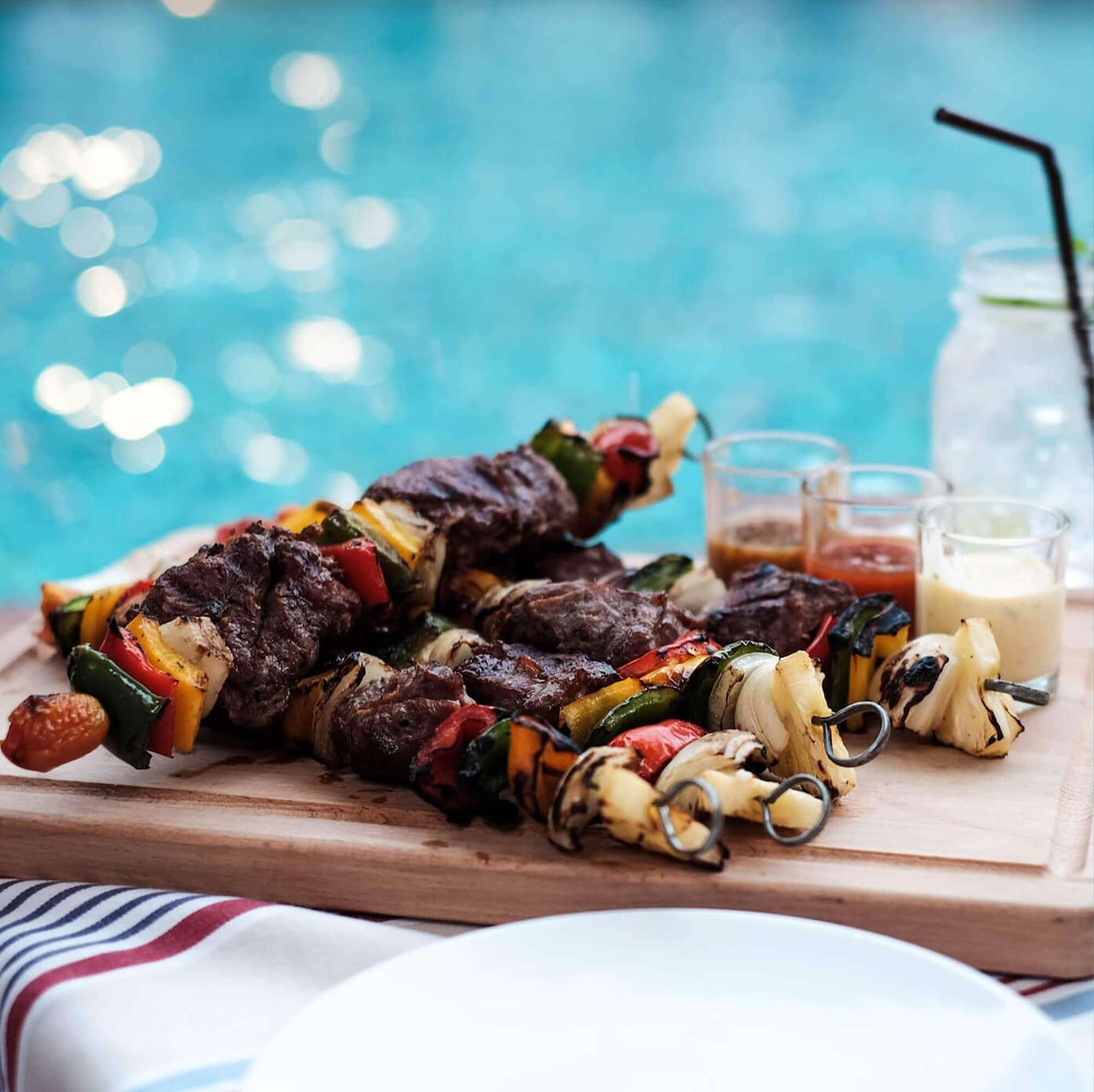 grilled meat and drinks near the pool