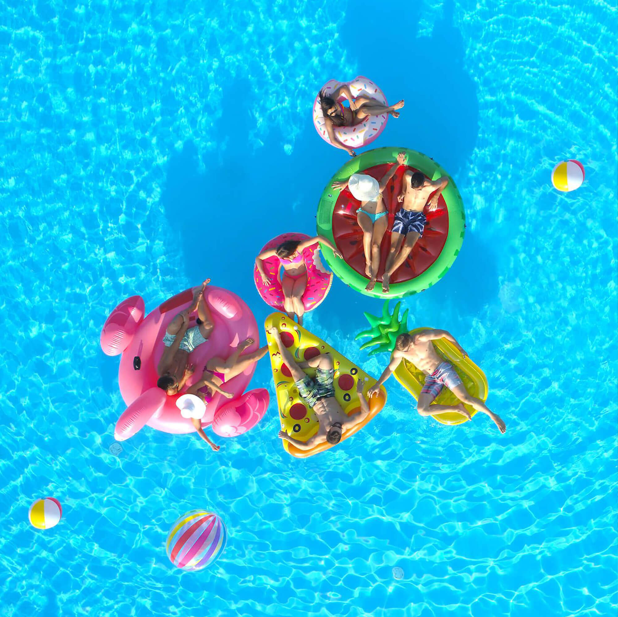 Group of people sun bathing in the pool