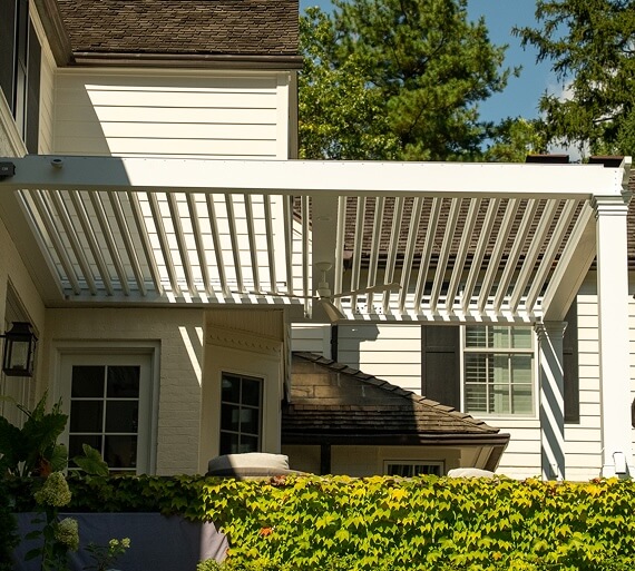 White Pivot 6 Louvers in the backyard of a white house