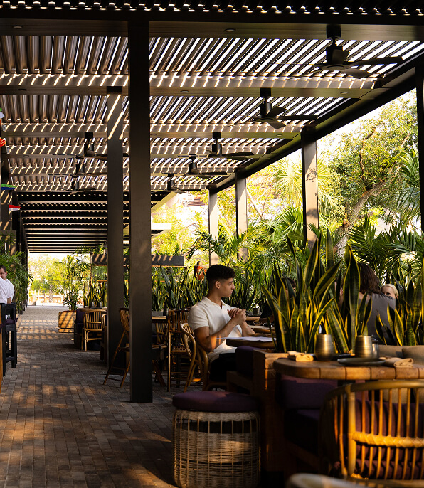 Custom pergola design in an outdoor restaurant patio with fans