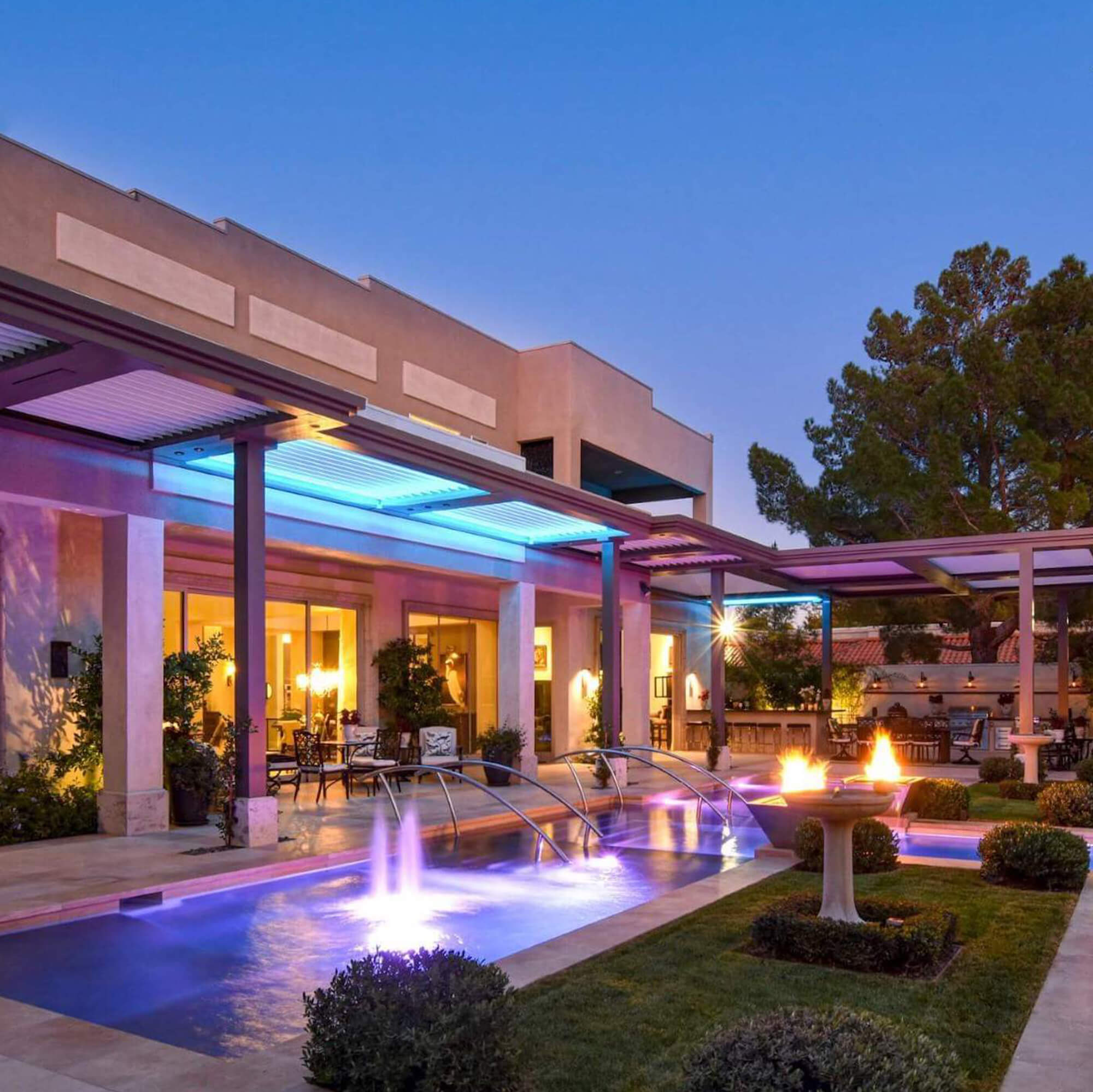Concrete house with T shape pool and outdoor Pergola night view