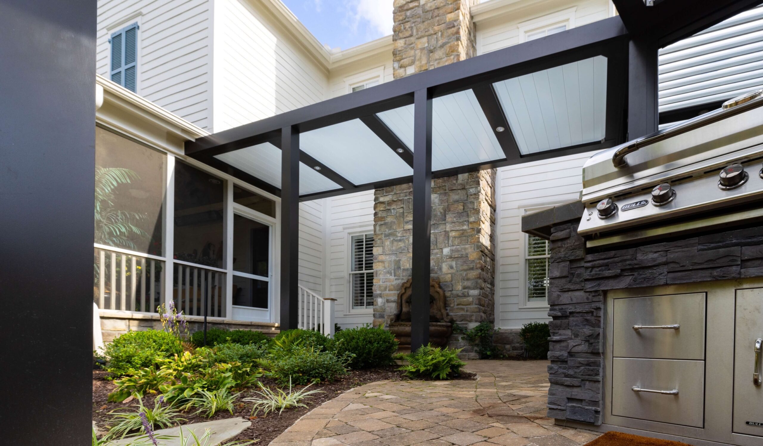 View from underneath a Pergola X with a Pan 6 canopy that covers a outdoor grilling area