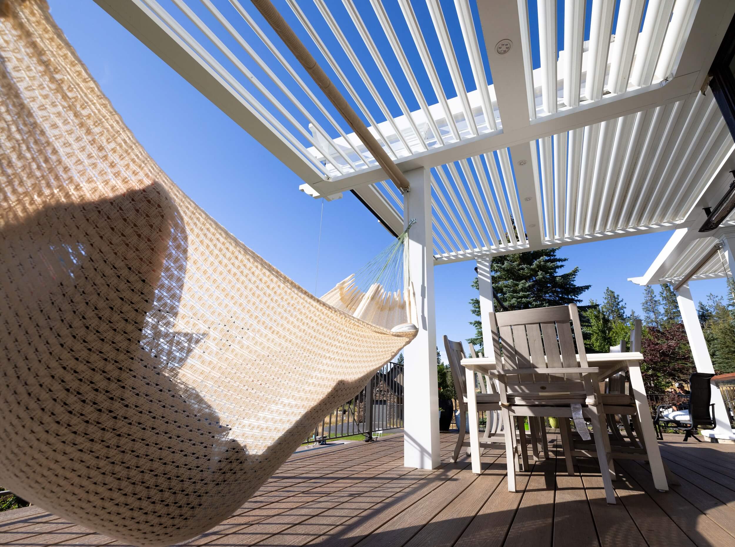 Person on hamock under a Pivot 6 Pergola