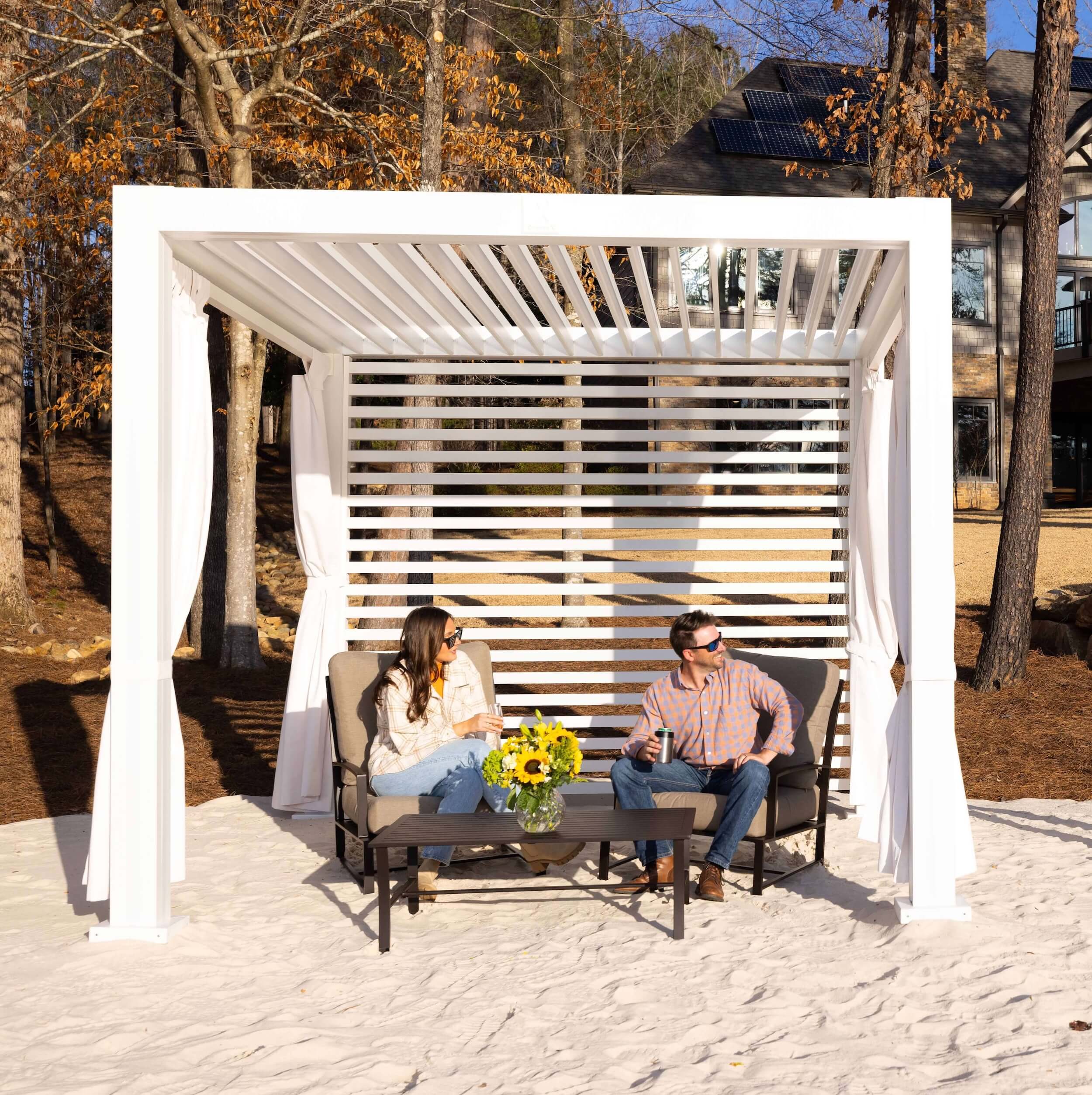 Two please sitting under a white Cabana X