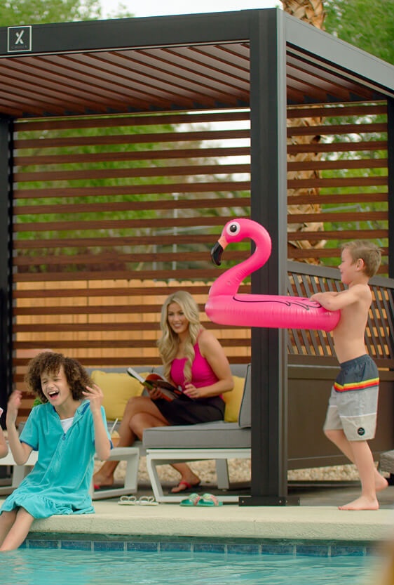 Kids playing by pool around Cabana X