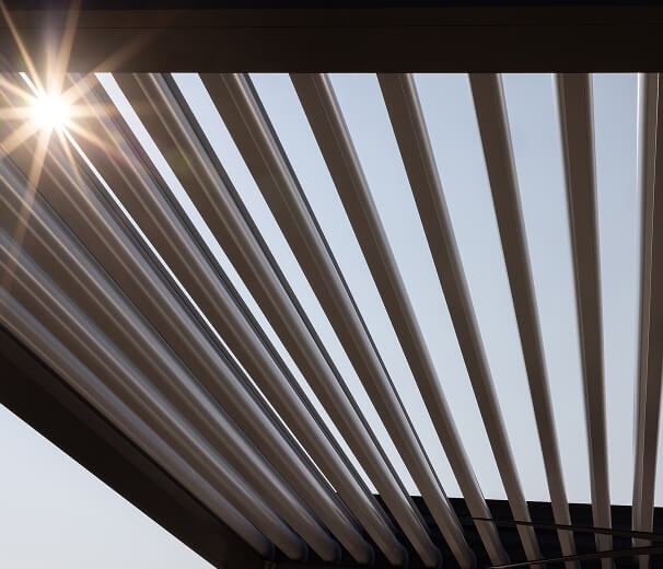 Close-up of Pivot 6 MAX louvers with sunlight beaming through