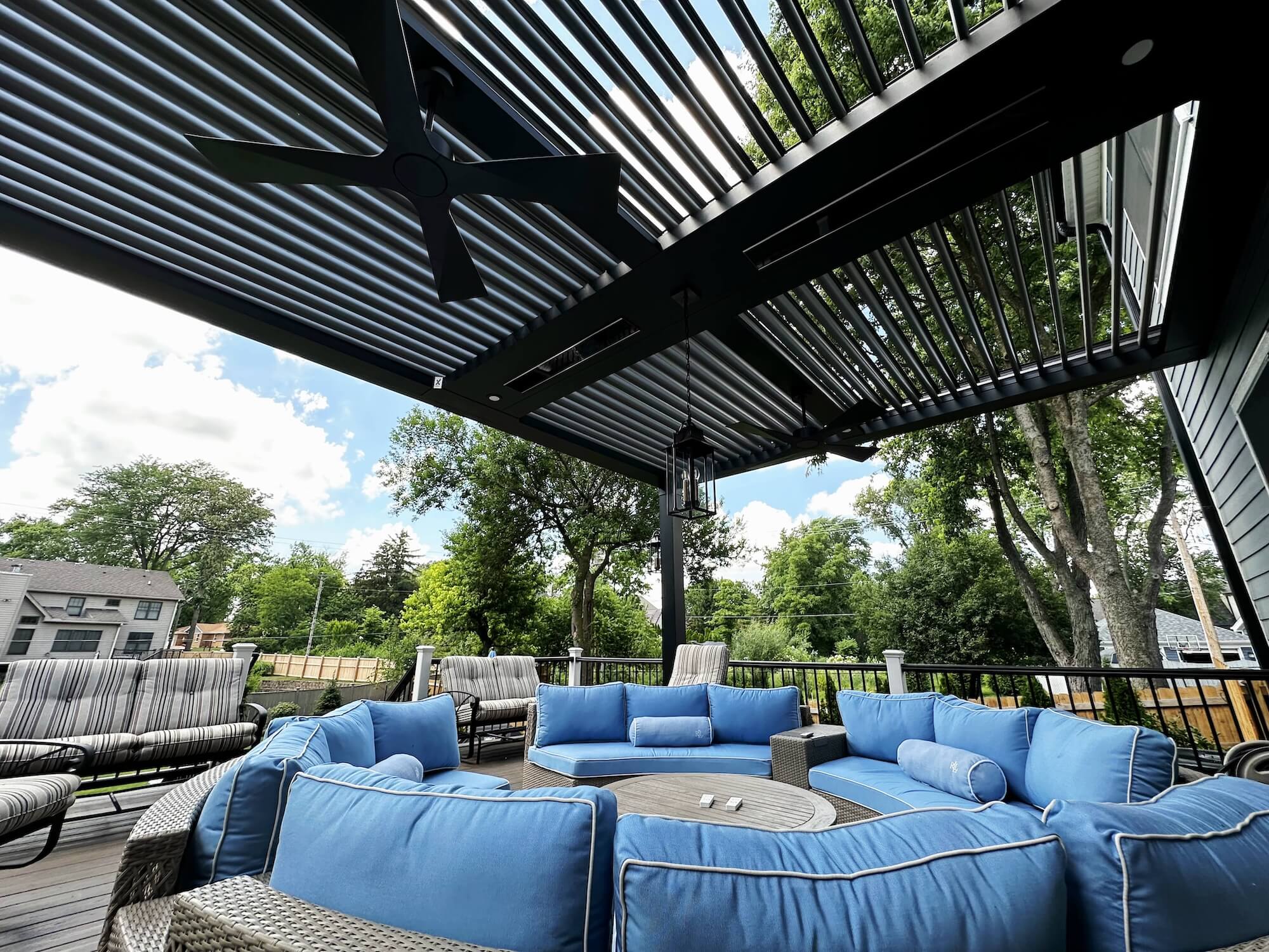Pergola X system back deck which allows for adjustable shade and weather protection