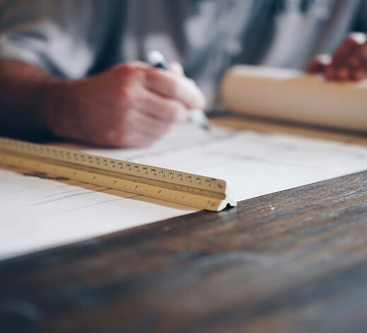 Person drawing plans