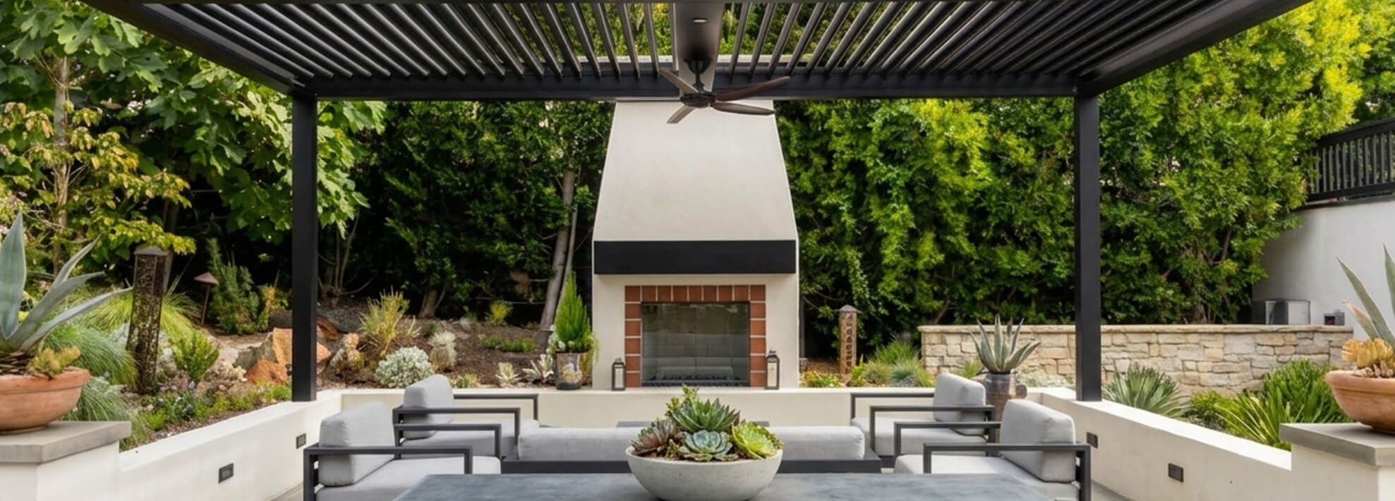 Black Pergola over an outdoor sitting area with a fireplace