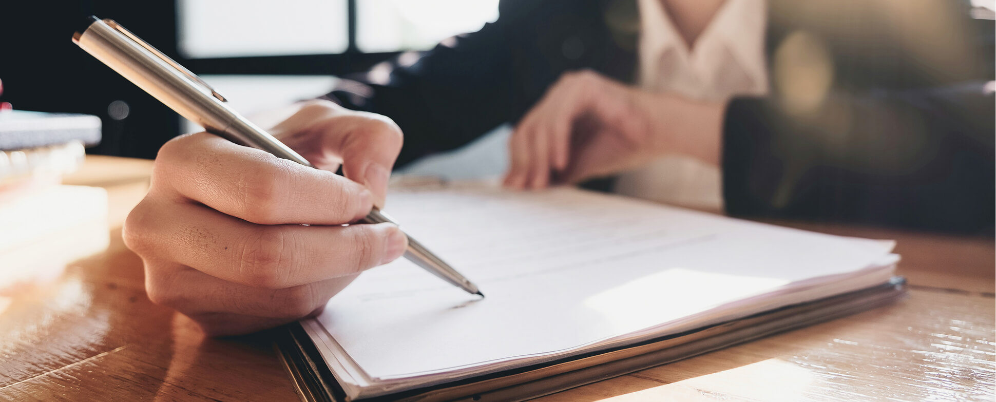 Person writing on paper