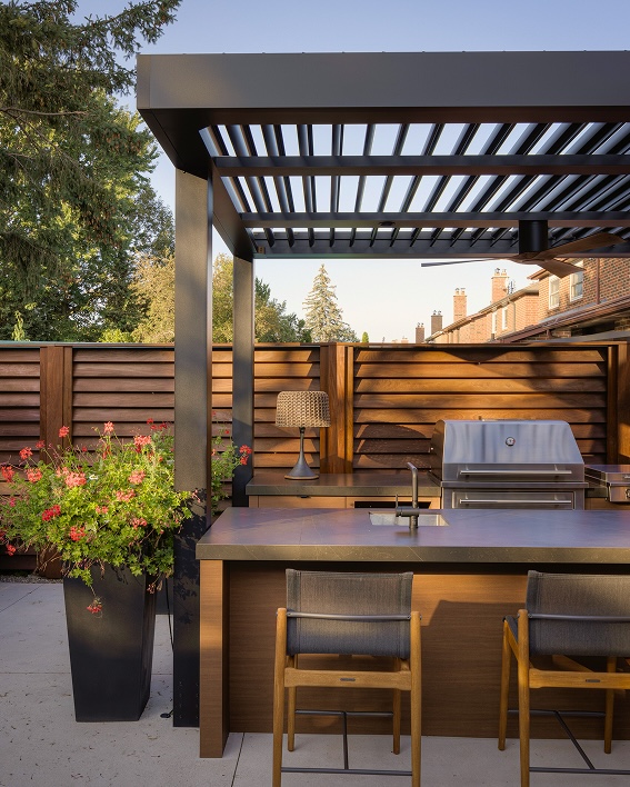 Black Pergola X in the back of a residential backyard