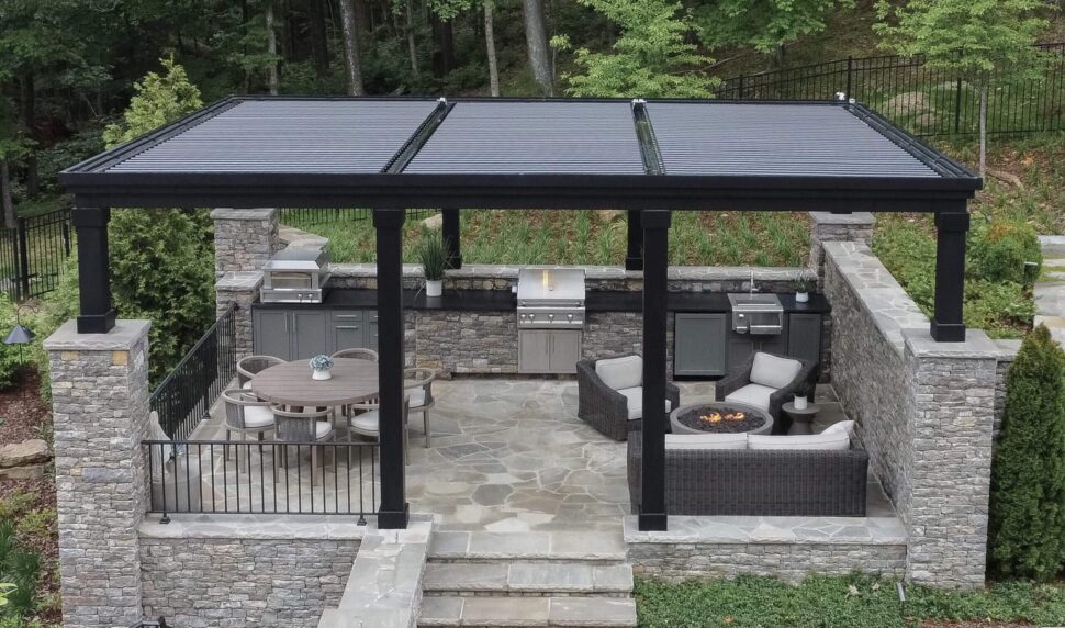 Aerial view of a black StruXure Pergola X covering a paved backyard lounge