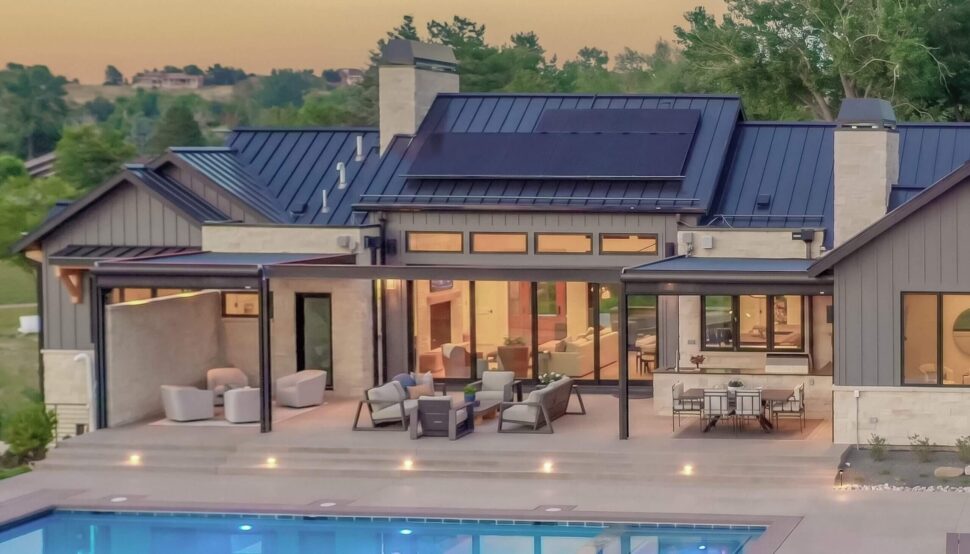 StruXure Pergola X covering a furnished elevated deck at the back of a home