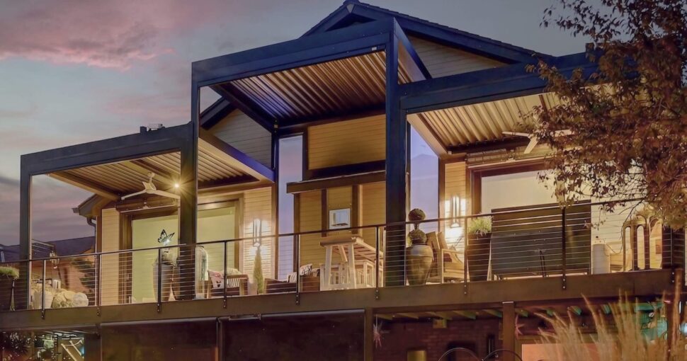Two dark StruXure Pergola X structures integrated into a luxury pool and spa design