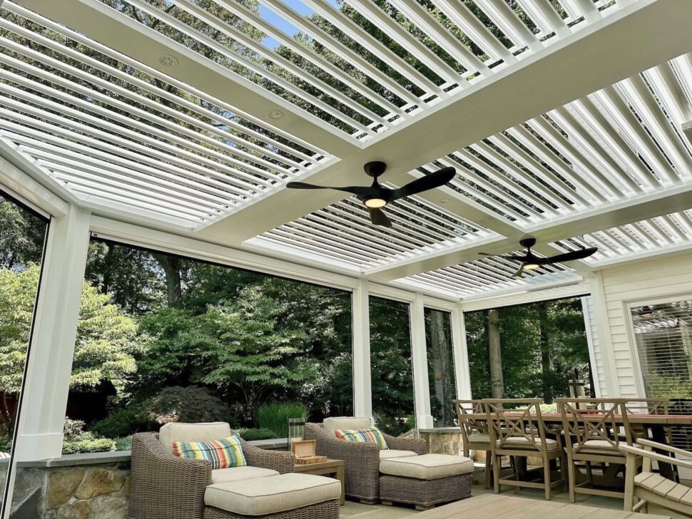 StruXure Pergola X shading a poolside dining and lounge area behind a home