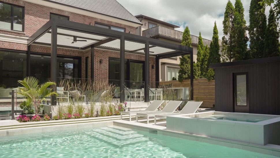 White StruXure Pergola X with architectural columns above poolside chaise lounges