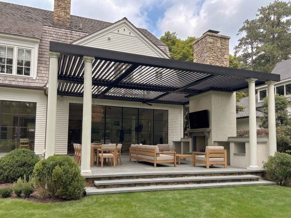 Dark StruXure Pergola X spanning a landscaped poolside lounge with chaise seating