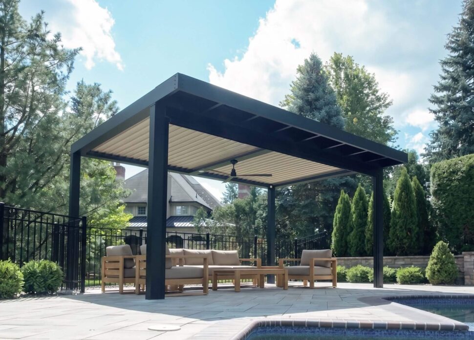 StruXure Pergola X covering a stone outdoor kitchen, dining area, and fire feature