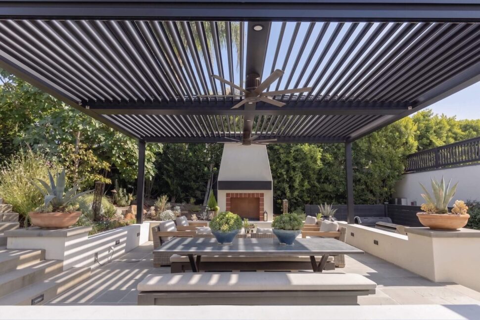 Dark StruXure Pergola X creating shade over a contemporary pool deck with lounge seating